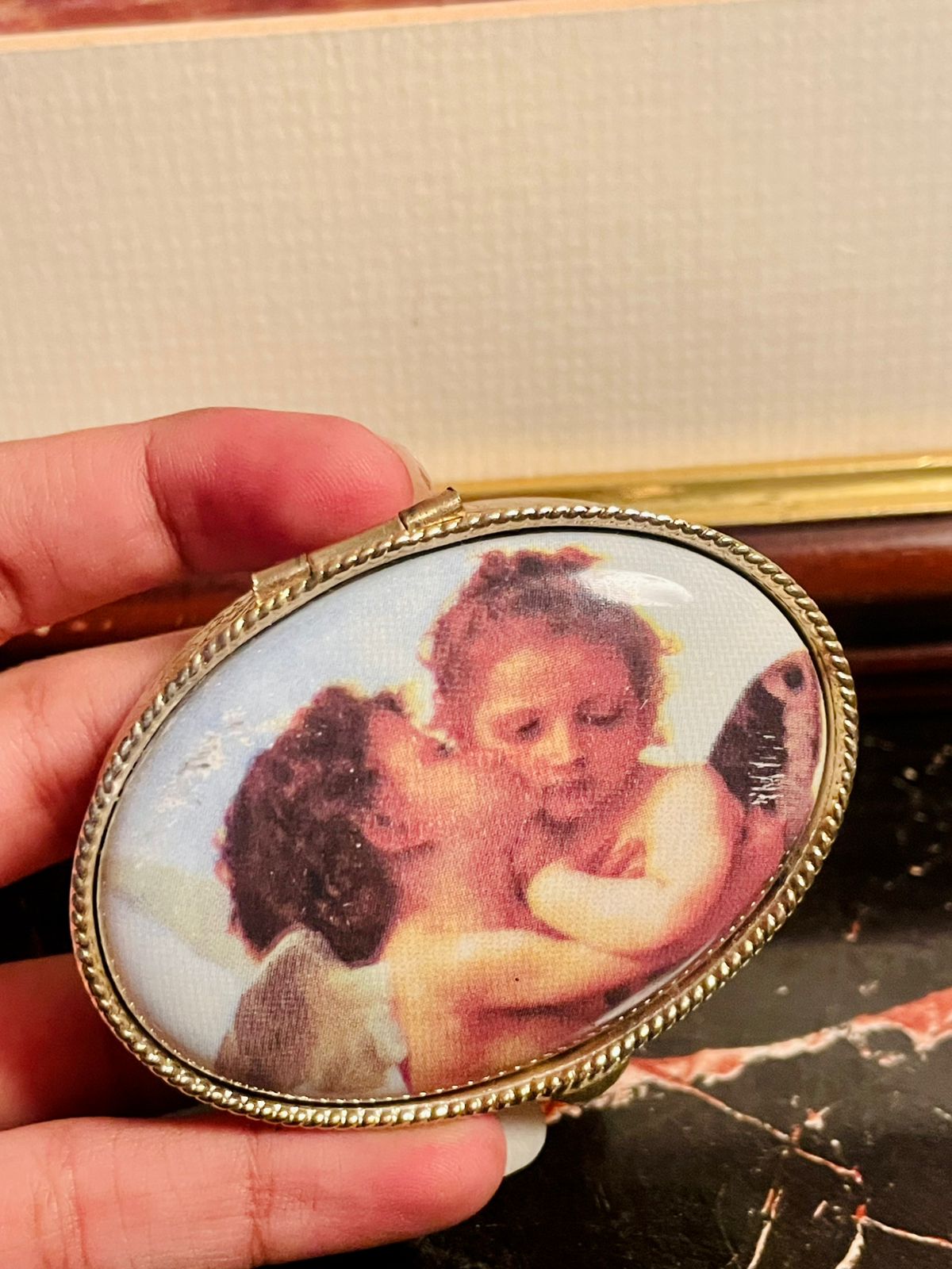 vintage trinket box, angel jewelry box, antique collectible box, decorative storage box, vintage keepsake box, metal trinket case, angel design box, antique vanity decor, collectible gift box, jewelry storage case, vintage angel decor, trinket box Pakistan, antique box England, vintage gift item, decorative jewelry case