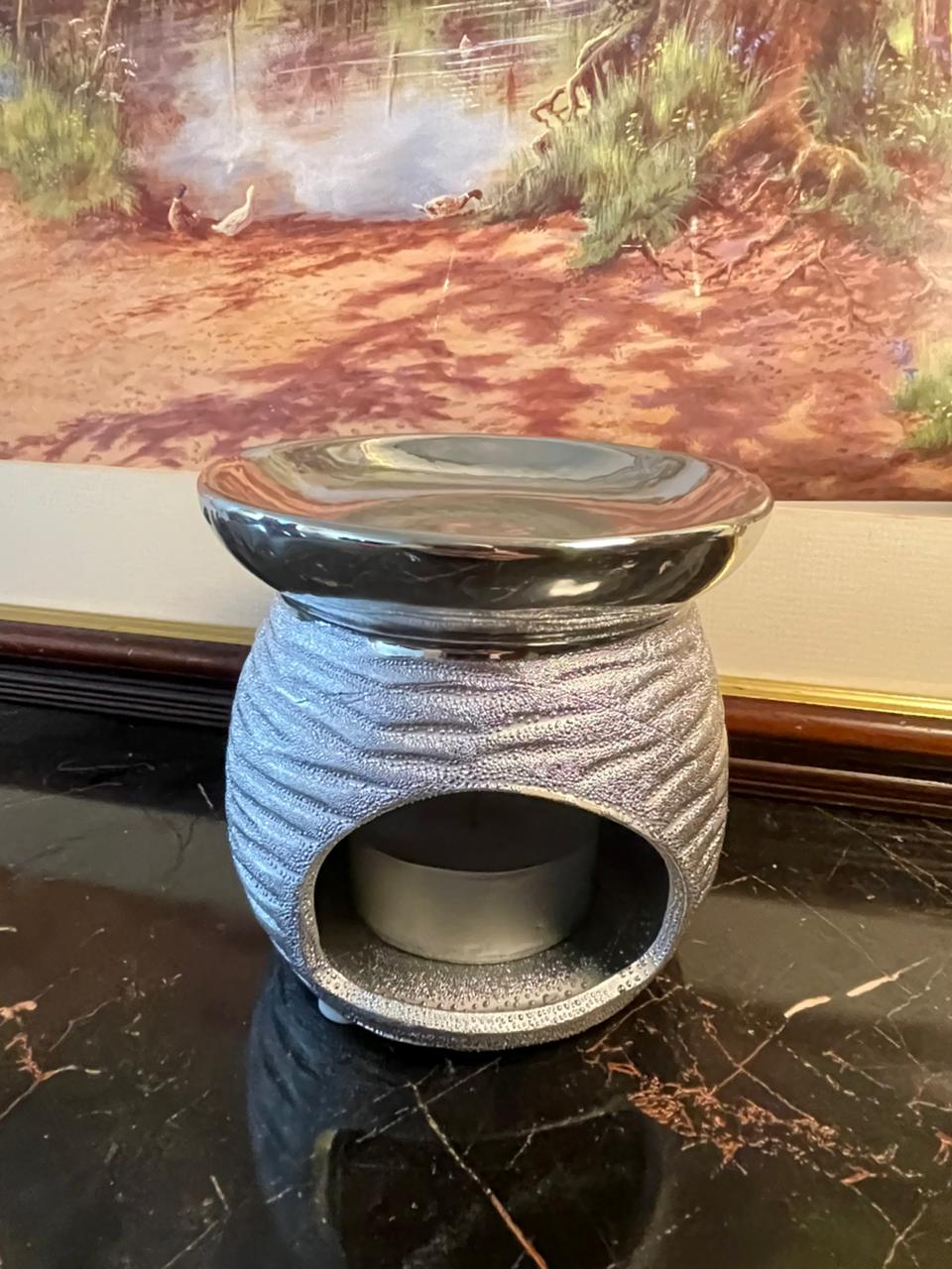 silver ceramic oil burner, wax melt warmer Pakistan, scented wax burner, essential oil warmer, home decor fragrance, vintage style oil burner, metallic silver wax warmer, gift for home lovers, rare thrift finds, elegant home fragrance decor
