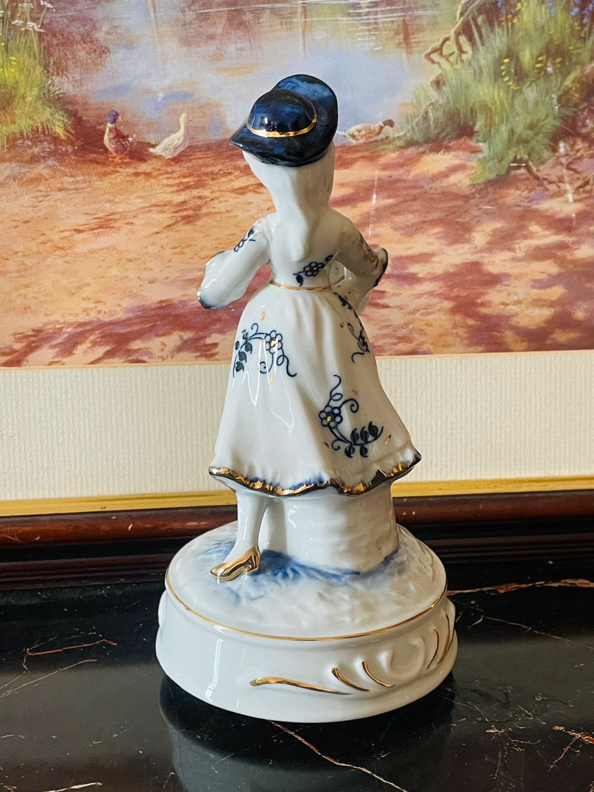 Musical Vintage Porcelain Girl Figurine with Hat & Basket – Blue Floral Dress (Music Box Base) Blue pottery