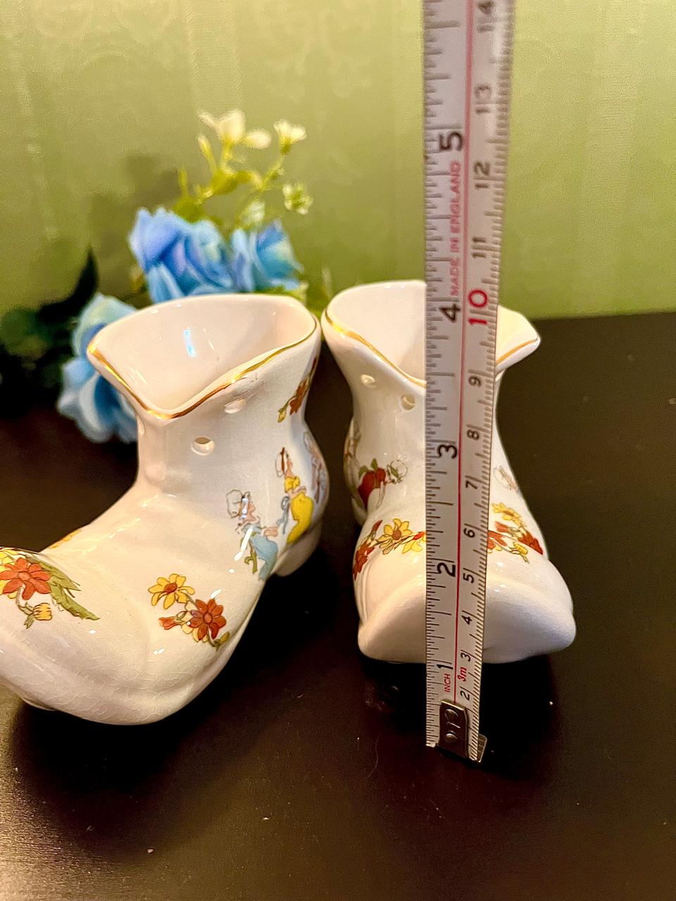 Boot vase pair with ruler showing approximately 5 inch height