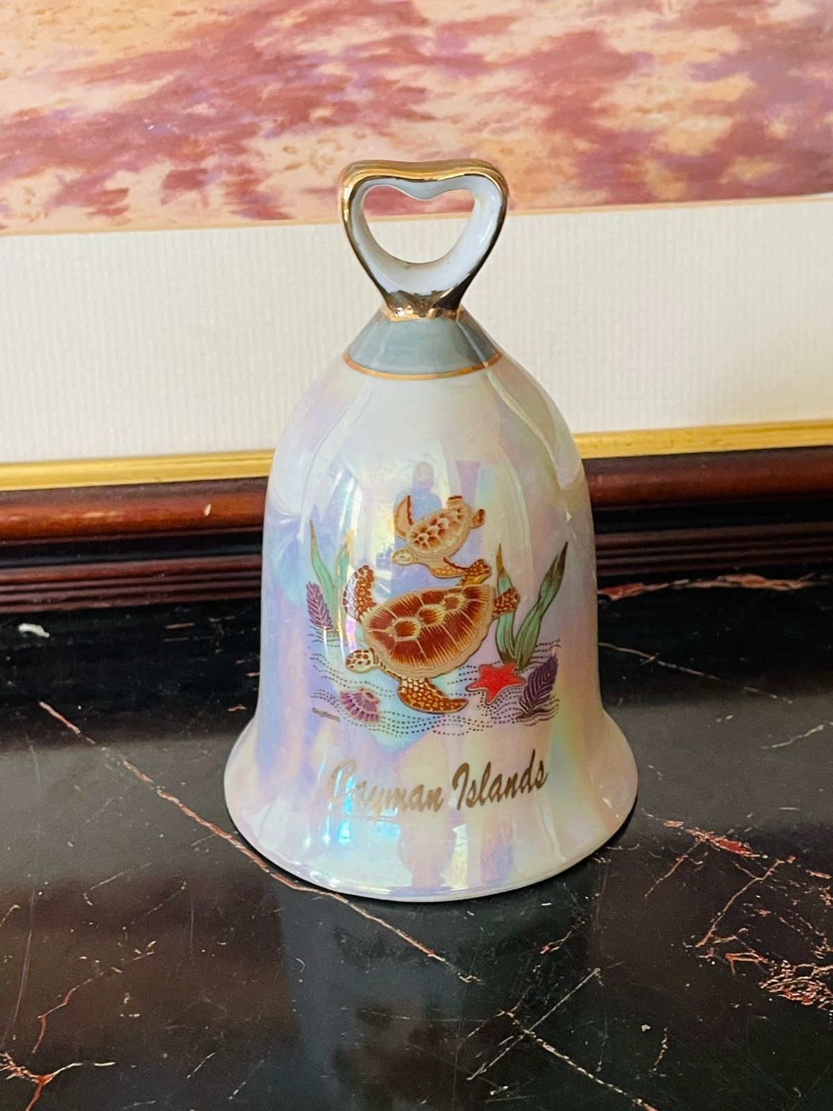 Cayman Islands souvenir, vintage porcelain bell, collectible travel bell, Caribbean souvenir collectibles, sea turtle design bell, iridescent glaze bell, coastal décor vintage, tropical island souvenirs, rare thrift finds, vintage Cayman Islands memorabilia