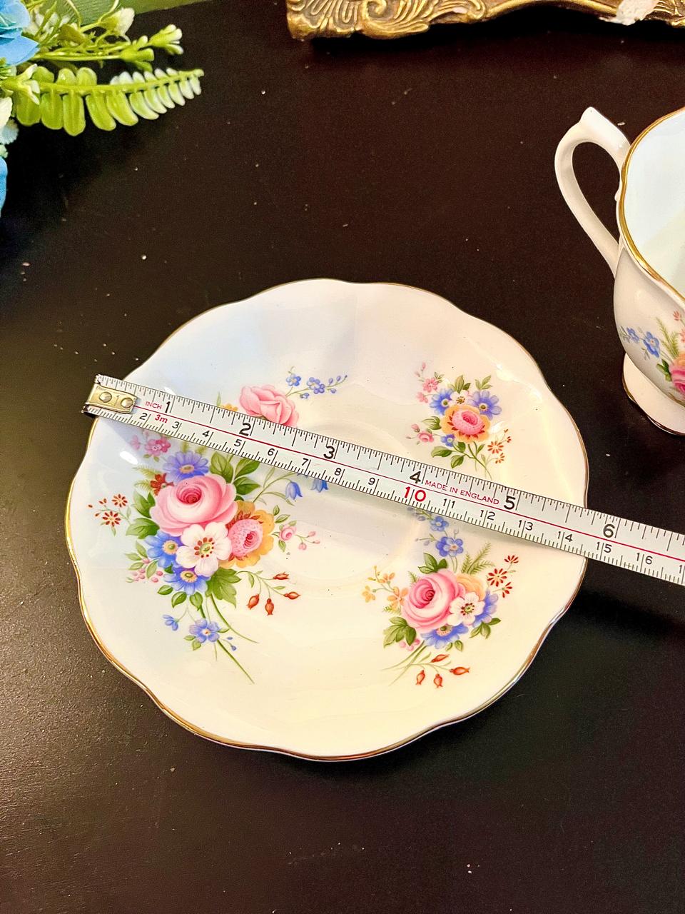 Royal Albert saucer with ruler showing approximately 5.5 inch diameter