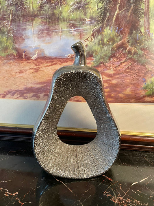 silver ceramic decor, pear shaped vase, modern centerpiece ornament, metallic home decor, ceramic pear decorative piece, silver fruit sculpture, elegant tabletop decoration, unique home accents, modern living room decor, artistic pear statue