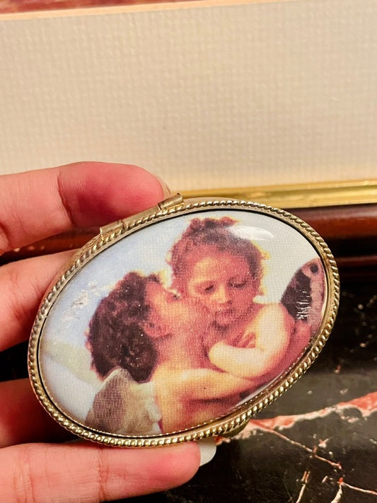 vintage trinket box, angel jewelry box, antique collectible box, decorative storage box, vintage keepsake box, metal trinket case, angel design box, antique vanity decor, collectible gift box, jewelry storage case, vintage angel decor, trinket box Pakistan, antique box England, vintage gift item, decorative jewelry case