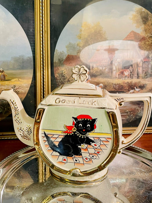 vintage teapot, good luck teapot, black cat decor, fortune teller cat, novelty teapot, collectible ceramics, retro kitchen decor, tea party decor, cat lover gift, playing cards design, gold accent teapot, aesthetic home decor, lucky charm teapot, cottagecore kitchen