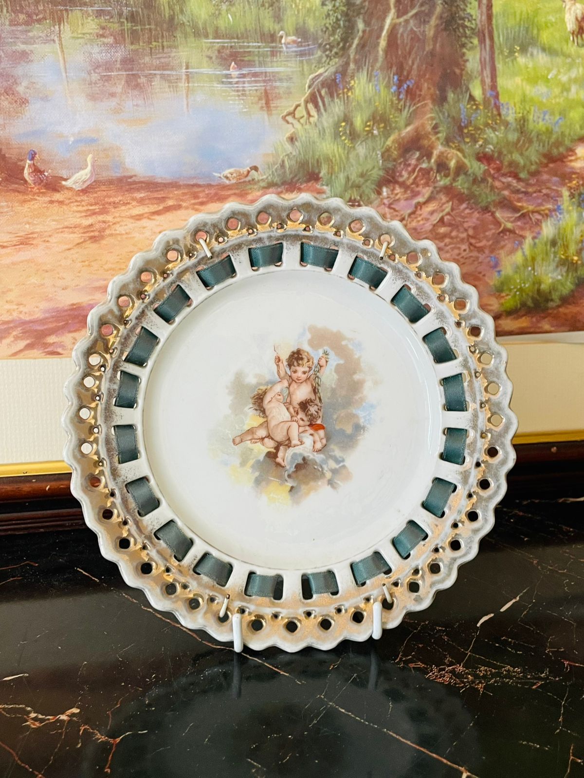 antique porcelain plate, vintage wall plate cherub, pierced edge decorative plate, gilt trim wall plate, collectible porcelain England, cherub motif plate, vintage hanging porcelain décor, ornate wall art plate, European vintage porcelain, heritage thrift treasures