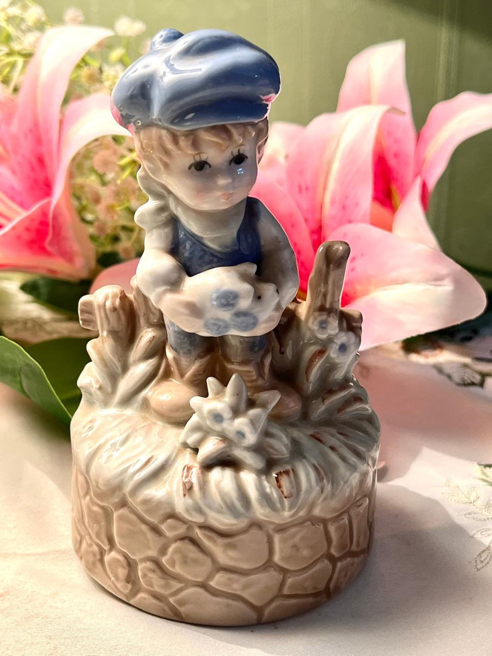 Vintage Porcelain Boy Figurine Musical on Stone Wall Base with Blue Cap Approx. 15 cm
