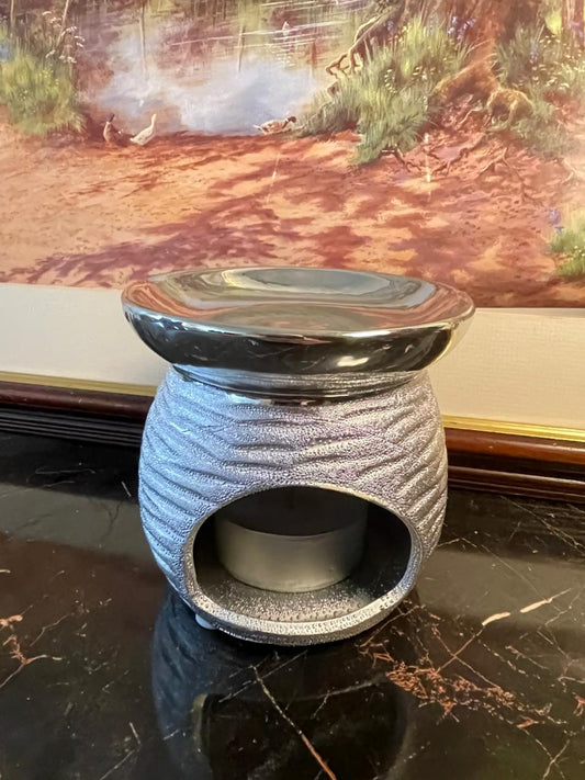 silver ceramic oil burner, wax melt warmer Pakistan, scented wax burner, essential oil warmer, home decor fragrance, vintage style oil burner, metallic silver wax warmer, gift for home lovers, rare thrift finds, elegant home fragrance decor