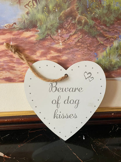 ceramic dog wall hanging, beware of dog kisses plaque, white ceramic wall décor, dog lover gift Pakistan, funny dog wall sign, vintage ceramic plaque England, pet corner wall hanging, rustic jute rope hanging décor, rare thrift finds Pakistan, European vintage wall décor