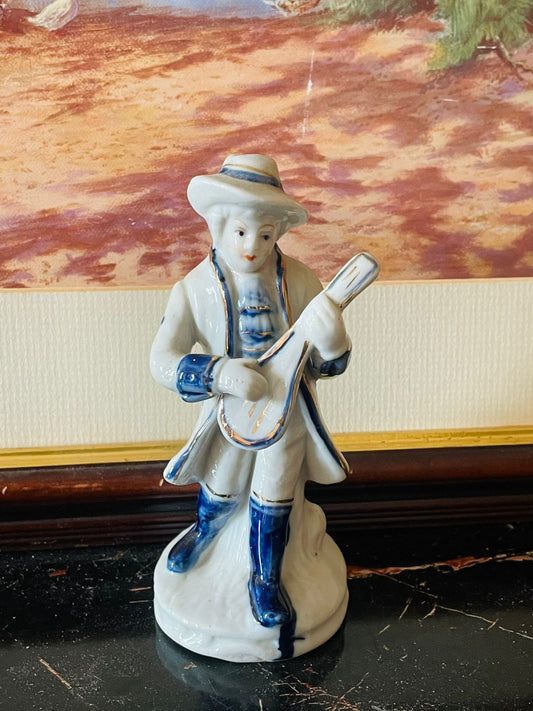 vintage musician figurine, porcelain collectible England, blue and white decor, antique figurine, European vintage collectible, classical musician statue, thrift home decor, rare porcelain find, vintage gift idea, elegant vintage shelf piece, rare thrift finds Pakistan, Sunset Kitchen vintage collection
