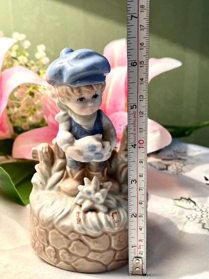 Vintage Porcelain Boy Figurine Musical on Stone Wall Base with Blue Cap Approx. 15 cm