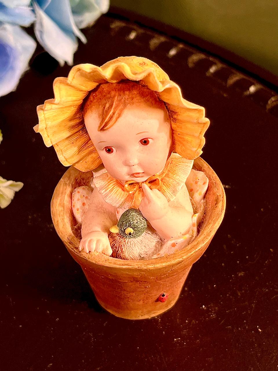 Child in Flowerpot with Bird Figurine 4 Inch