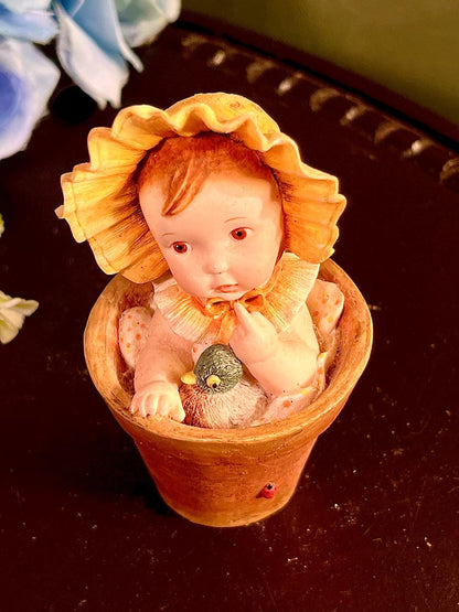 Child in Flowerpot with Bird Figurine 4 Inch