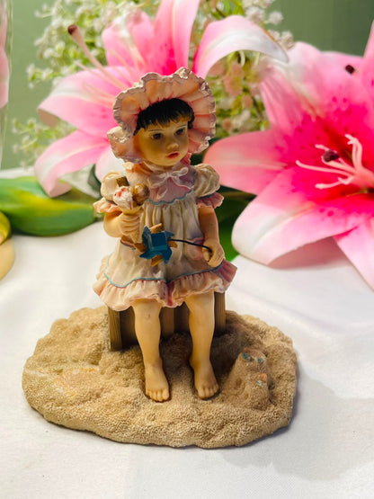 Vintage Style Seated Girl Figurine with Bonnet 10 cm