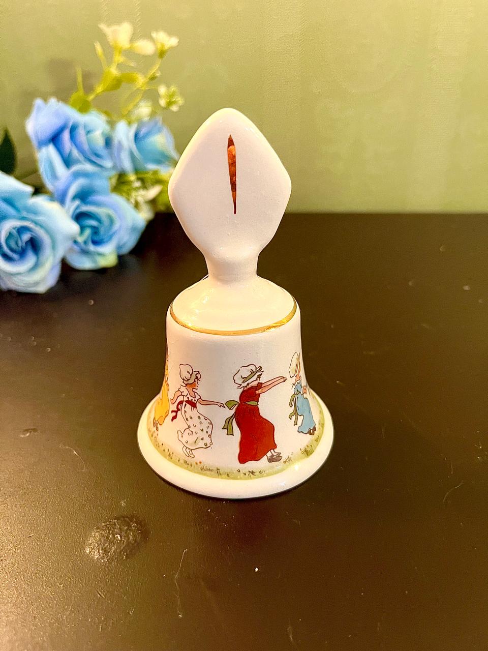 Vintage nursery rhyme dinner bell with children in bonnets dancing