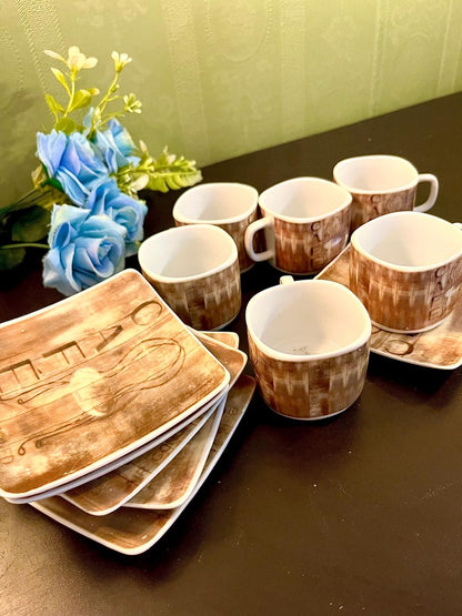 CAFE cups and square saucers arranged on table