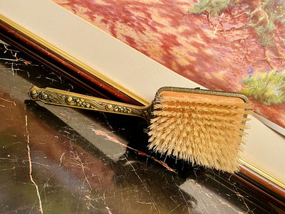 vintage brush, antique vanity brush, brass floral handle brush, embroidered back brush, England vintage collectible, ornate brass hand brush, antique grooming set, vintage decorative brush, Victorian vanity accessory, collectible antique brush, old vanity set Pakistan, vintage brush for decor