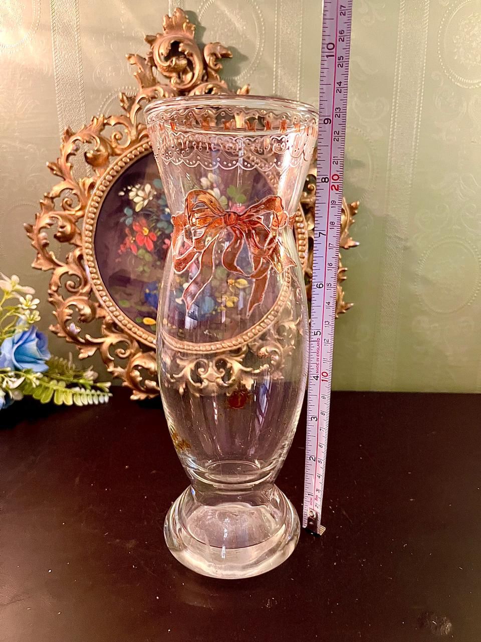 Clear glass bow vase shown with measuring tape indicating approx. 10 inch height
