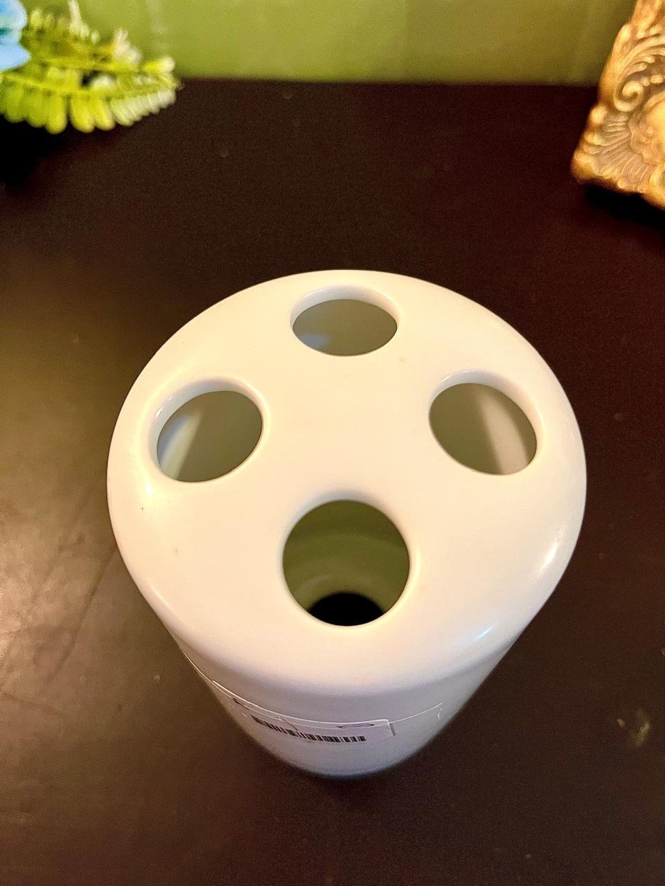 Top-down view of vintage white ceramic posy vase showing four flower-stem holes