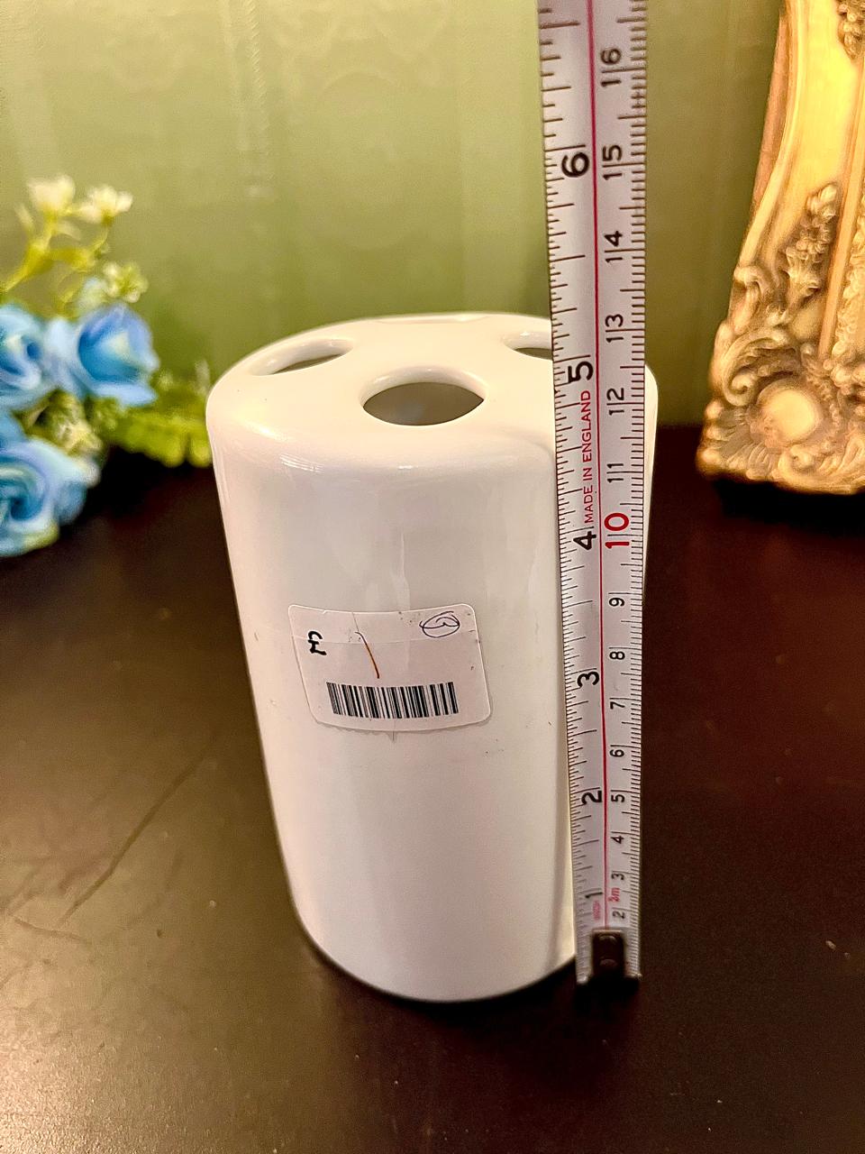 Vintage white ceramic posy vase with ruler showing 5 inch height