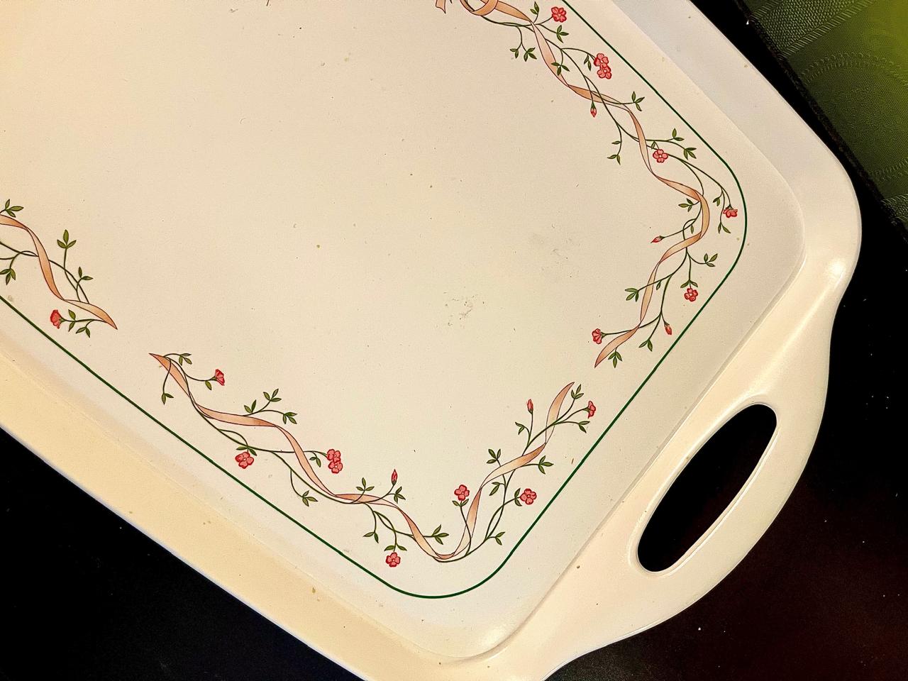 Close-up of ribbon and rosebud border along tray edge