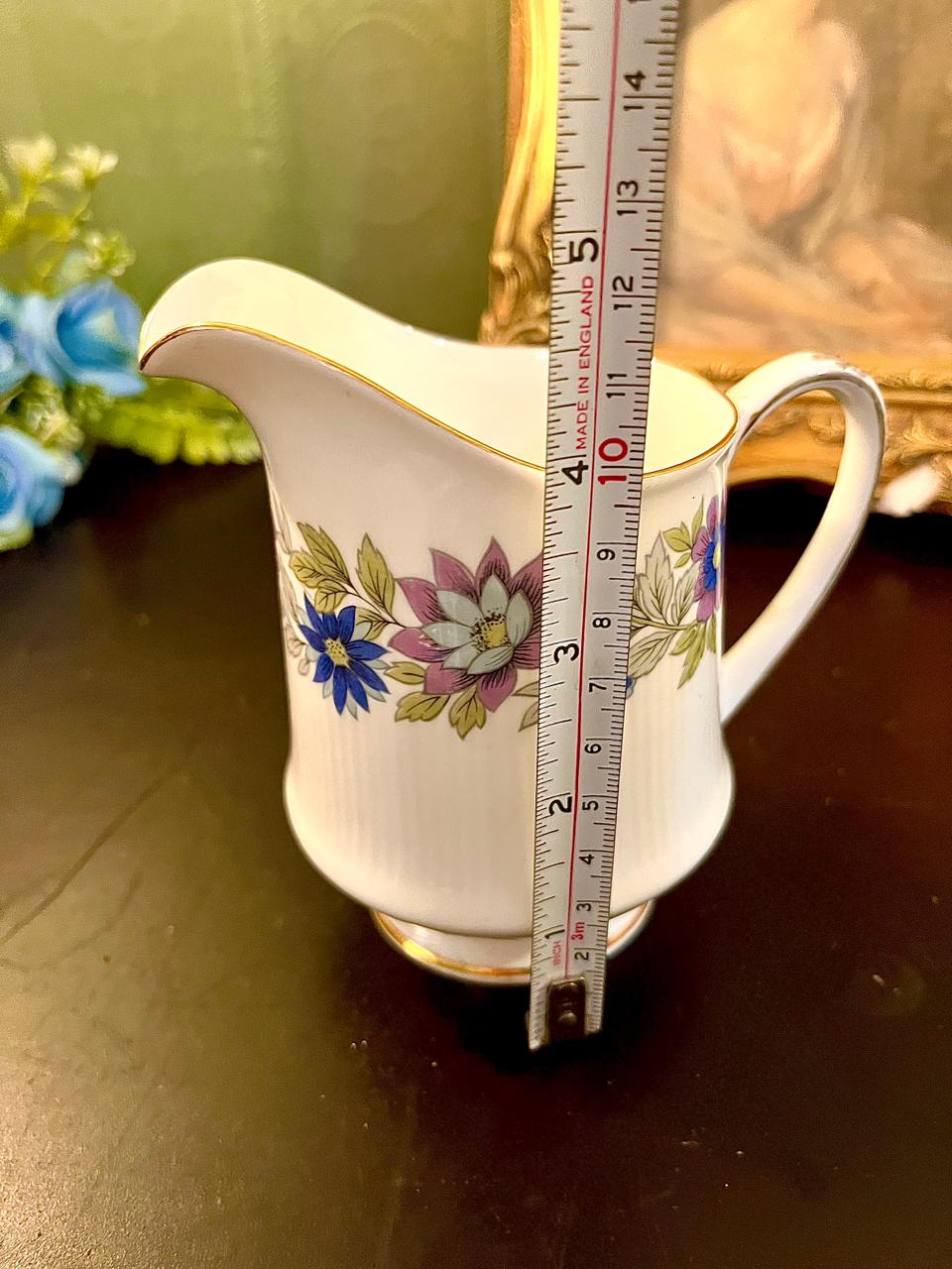 Vintage floral chintz bone china creamer with ruler showing 4 inch height