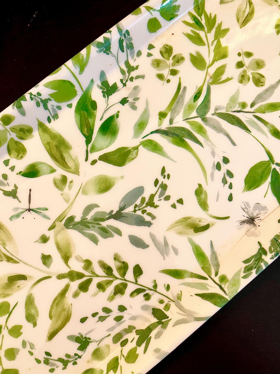 Close-up of green leaf print with dragonfly and butterfly detail