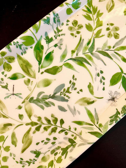 Close-up of green leaf print with dragonfly and butterfly detail