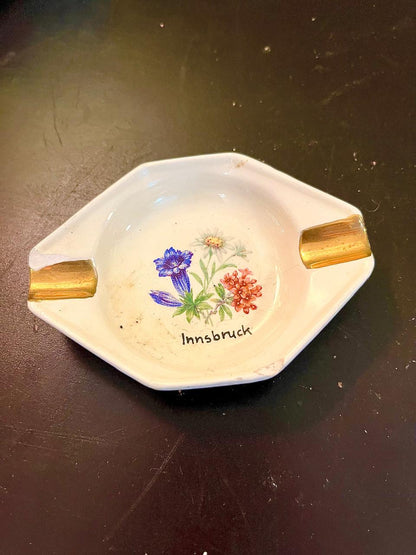 Vintage Innsbruck souvenir ashtray with gold handles and floral design