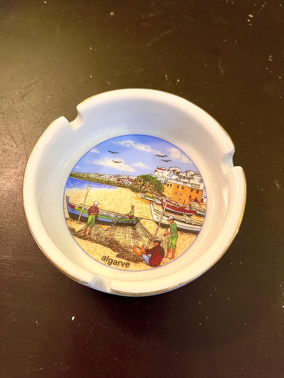 Vintage ceramic ashtray with painted harbor town scene, top view