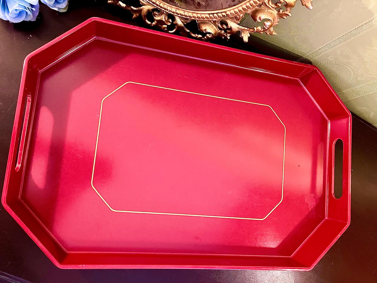 Red glossy octagonal serving tray with gold trim line and cut-out handles