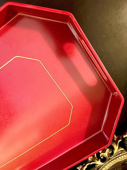 Close-up of red octagonal tray corner and gold trim detail