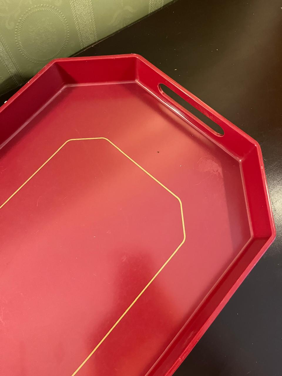 Close-up of cut-out handle on red octagonal tray
