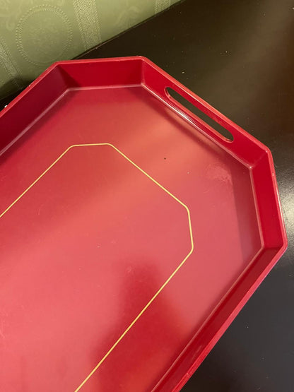 Close-up of cut-out handle on red octagonal tray