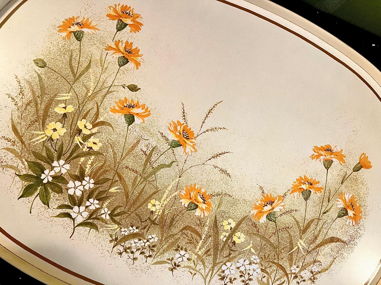 Close-up of orange wildflower and grasses print on oval tray