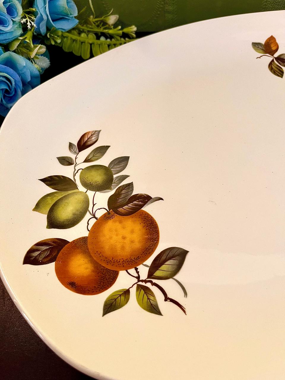 Close-up of hand-painted mandarin orange motif on vintage ironstone platter