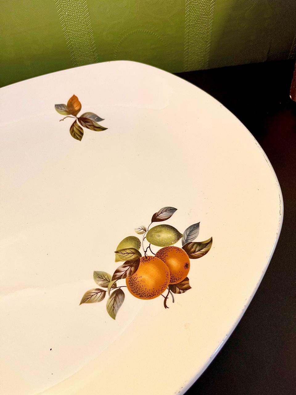 Vintage ironstone platter showing leaf and orange detail on opposite corner