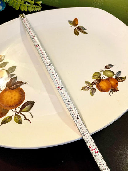 Vintage ironstone platter with measuring tape showing 12 inch length