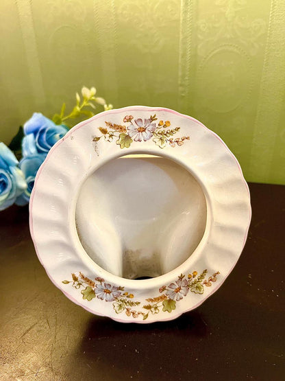 Vintage round ceramic trinket dish with multicolor floral pattern, top view