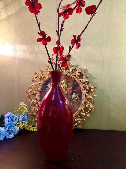 Burgundy ceramic bud vase with red faux blossom branches