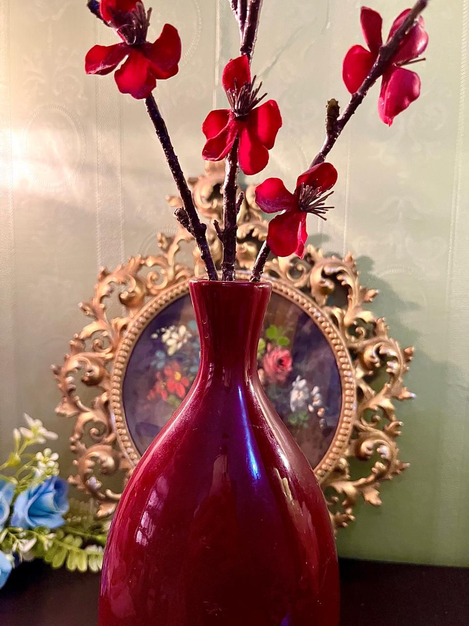 Close-up of burgundy ceramic vase neck and glossy glaze