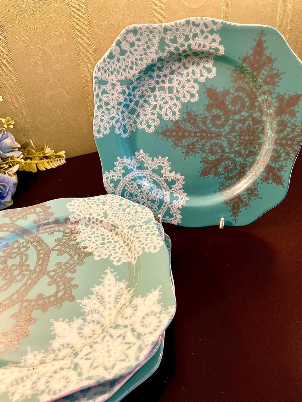 Turquoise square dessert plates with white lace doily print