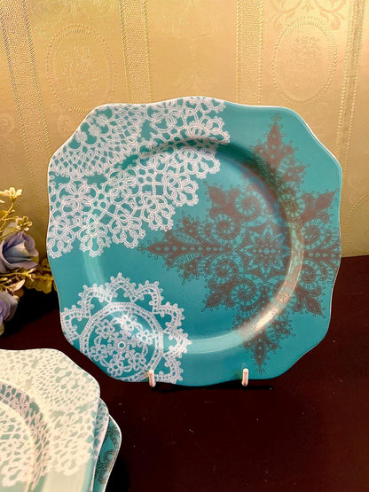 Close up of turquoise plate with bronze lace medallion pattern on display stand