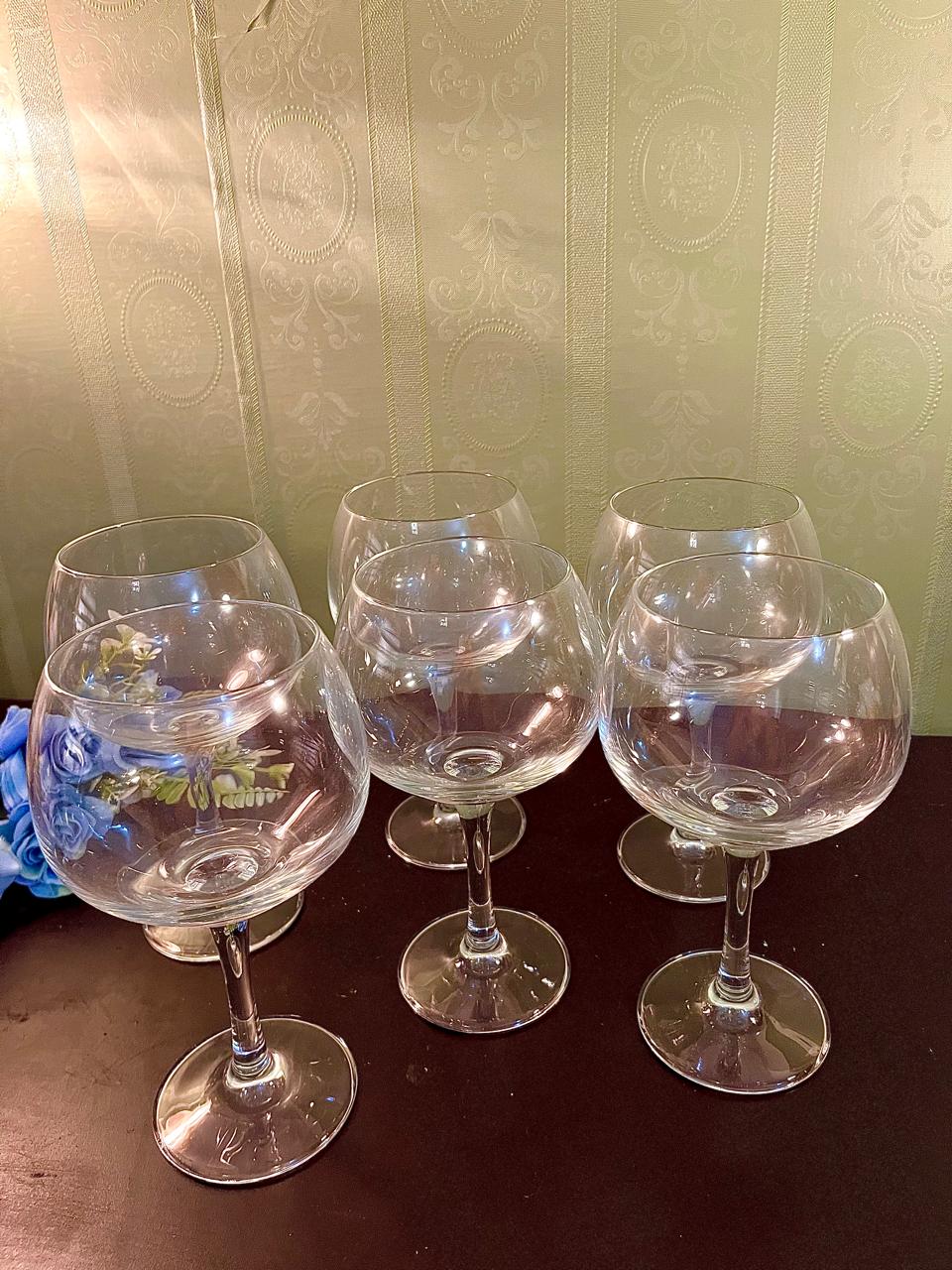 Set of six crystal balloon wine glasses grouped together