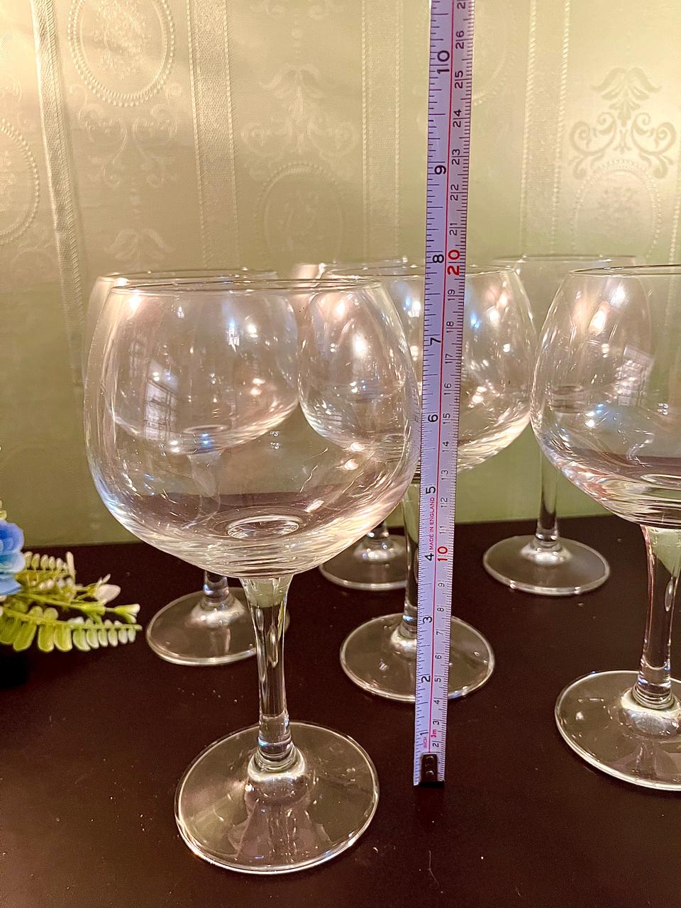 Wine glass with ruler showing approximately 9 inch height