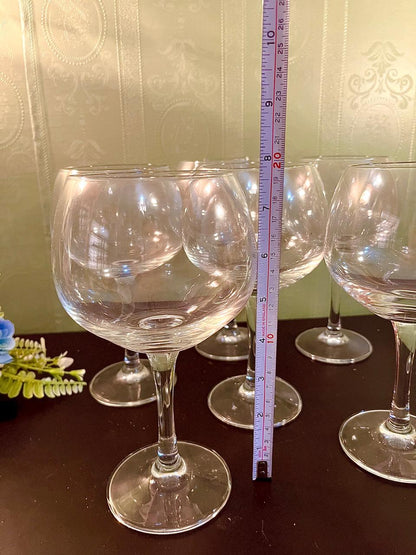 Wine glass with ruler showing approximately 9 inch height