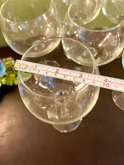 Wine glass rim with ruler showing approximately 3.5 inch diameter